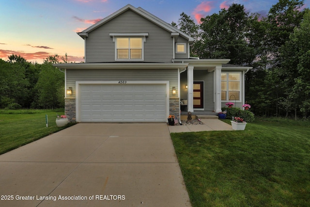 4269 Tamarack St, Holt, MI 48842 - traditional-style house featuring a yard, an attached garage, concrete driveway, and stone siding