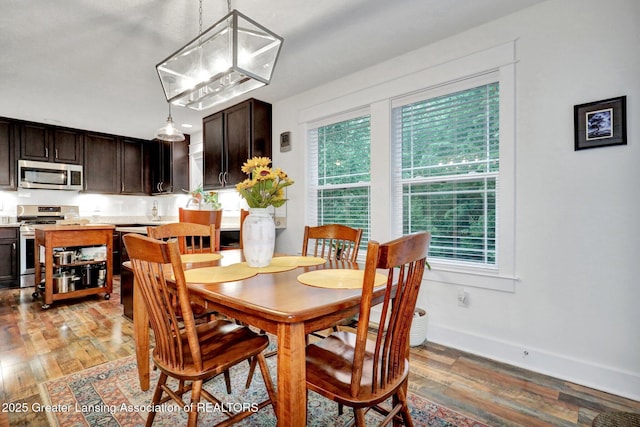 4269 Tamarack St, Holt, MI 48842 - dining space with light wood-style floors and baseboards