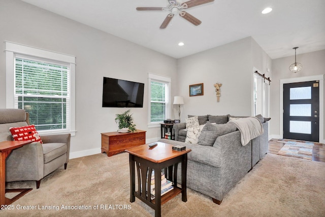4269 Tamarack St, Holt, MI 48842 - living area with a barn door, light colored carpet, ceiling fan, baseboards, and recessed lighting