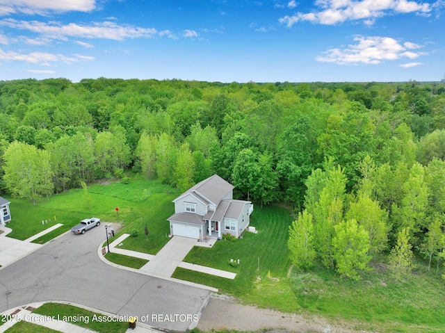 4269 Tamarack St, Holt, MI 48842 - aerial view of property and surrounding area featuring a heavily wooded area