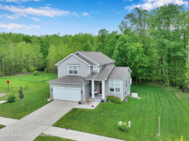 4269 Tamarack St, Holt, MI 48842 - traditional-style house with a garage, concrete driveway, a front yard, a wooded view, and roof with shingles