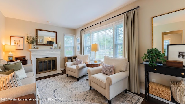 1451 Harvard Rd, East Lansing, MI 48823 - living area featuring a glass covered fireplace, wood finished floors, and baseboards