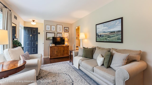 1451 Harvard Rd, East Lansing, MI 48823 - living area with dark wood-style floors and baseboards
