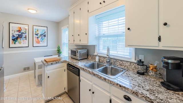 1451 Harvard Rd, East Lansing, MI 48823 - kitchen with stainless steel dishwasher, a sink, healthy amount of natural light, and white cabinets