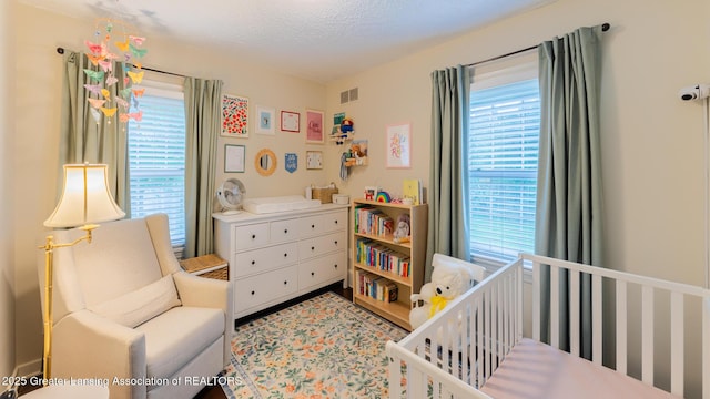 1451 Harvard Rd, East Lansing, MI 48823 - bedroom with a crib and multiple windows
