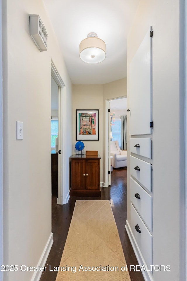 1451 Harvard Rd, East Lansing, MI 48823 - hallway featuring healthy amount of natural light, dark wood-style flooring, and baseboards