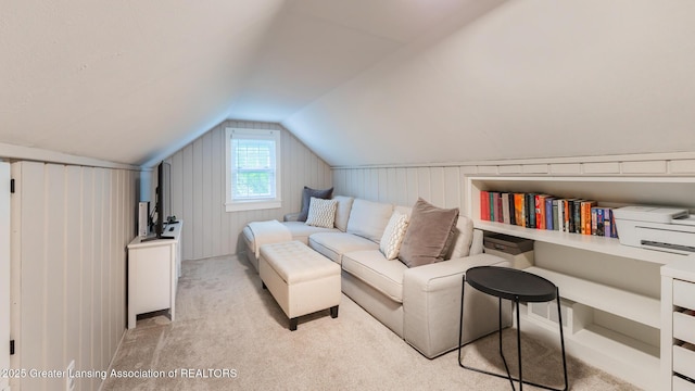 1451 Harvard Rd, East Lansing, MI 48823 - living area with lofted ceiling, carpet flooring, and wood walls