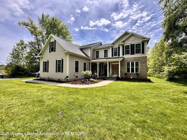 11195 W Herbison Rd, Eagle, MI 48822 - traditional-style home with a porch, a front yard, and brick siding