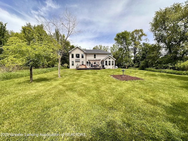 11195 W Herbison Rd, Eagle, MI 48822 - view of front of house featuring a deck and a front lawn