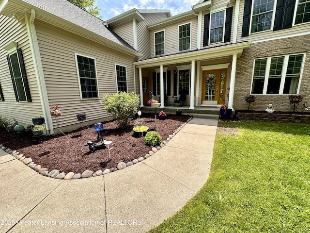 11195 W Herbison Rd, Eagle, MI 48822 - property entrance featuring covered porch, a lawn, and a shingled roof