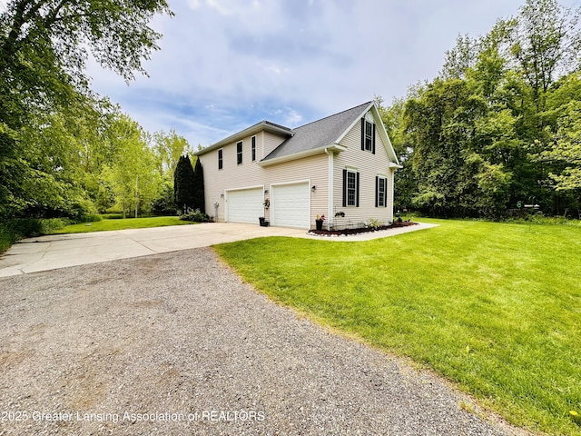 11195 W Herbison Rd, Eagle, MI 48822 - view of front of property with concrete driveway, an attached garage, and a front yard
