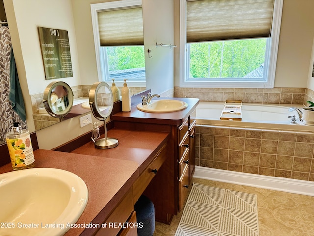 11195 W Herbison Rd, Eagle, MI 48822 - full bathroom with healthy amount of natural light, double vanity, and a bath