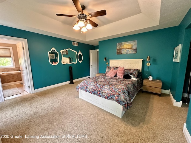 11195 W Herbison Rd, Eagle, MI 48822 - bedroom with carpet floors, a raised ceiling, baseboards, and connected bathroom