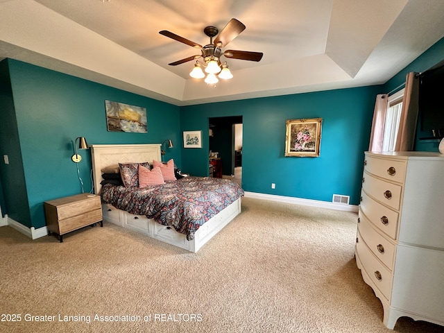 11195 W Herbison Rd, Eagle, MI 48822 - bedroom with a tray ceiling, carpet, baseboards, and ceiling fan