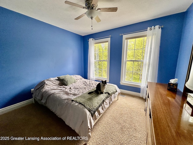 11195 W Herbison Rd, Eagle, MI 48822 - bedroom with baseboards, carpet, a ceiling fan, and a textured ceiling