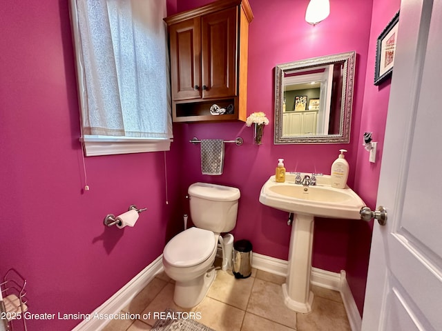 11195 W Herbison Rd, Eagle, MI 48822 - half bathroom with toilet, baseboards, and tile patterned floors