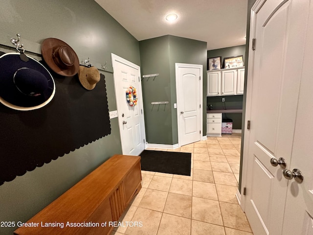11195 W Herbison Rd, Eagle, MI 48822 - mudroom with light tile patterned floors and baseboards
