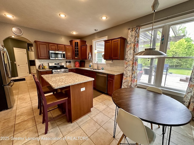 11195 W Herbison Rd, Eagle, MI 48822 - kitchen featuring stainless steel appliances, a sink, backsplash, a center island, and recessed lighting