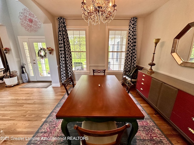 11195 W Herbison Rd, Eagle, MI 48822 - dining room featuring wood finished floors and a chandelier
