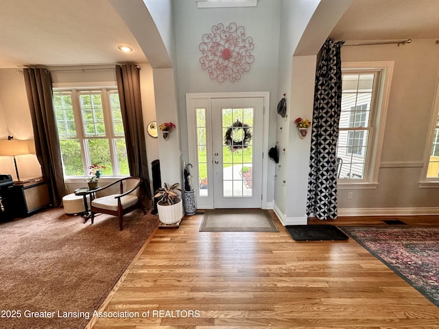 11195 W Herbison Rd, Eagle, MI 48822 - entryway featuring wood finished floors, arched walkways, and plenty of natural light