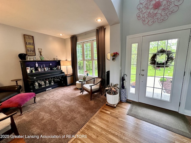 11195 W Herbison Rd, Eagle, MI 48822 - foyer entrance with arched walkways, wood finished floors, and recessed lighting