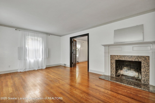 350 Kensington Rd, East Lansing, MI 48823 - unfurnished living room featuring crown molding, light wood-style flooring, baseboards, and a premium fireplace
