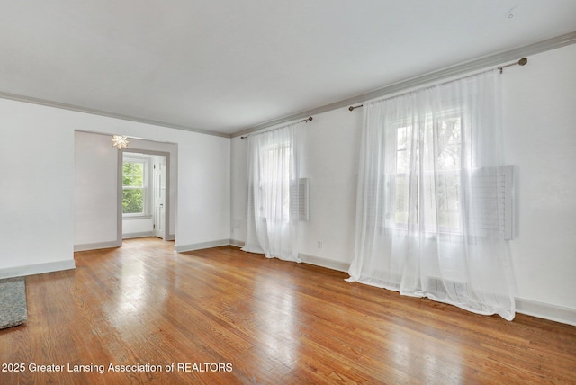 350 Kensington Rd, East Lansing, MI 48823 - spare room featuring light wood finished floors, ornamental molding, and baseboards