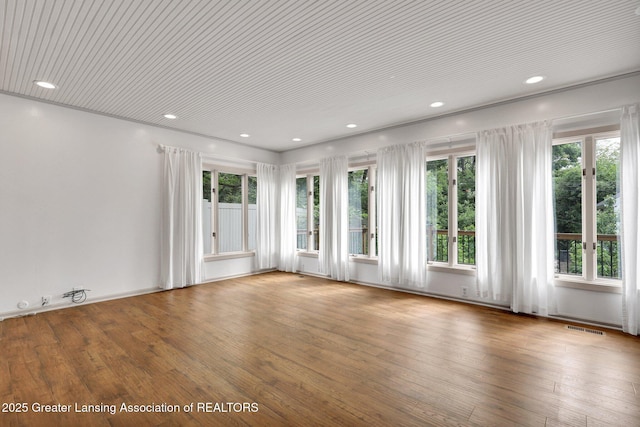 350 Kensington Rd, East Lansing, MI 48823 - unfurnished room with healthy amount of natural light, recessed lighting, and hardwood / wood-style flooring