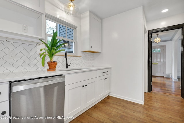 350 Kensington Rd, East Lansing, MI 48823 - kitchen with dishwasher, a sink, light countertops, and white cabinets