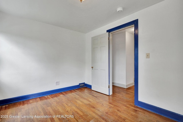 350 Kensington Rd, East Lansing, MI 48823 - empty room with baseboards, light wood-style flooring, and a smoke detector