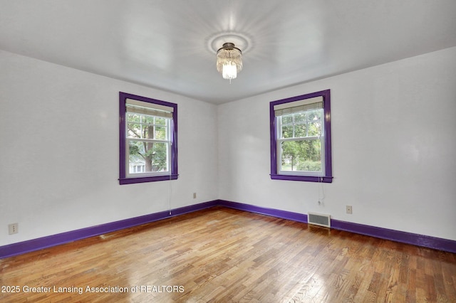 350 Kensington Rd, East Lansing, MI 48823 - spare room featuring healthy amount of natural light, light wood-style floors, and baseboards
