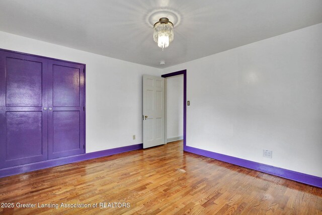 350 Kensington Rd, East Lansing, MI 48823 - unfurnished bedroom with baseboards and light wood-type flooring