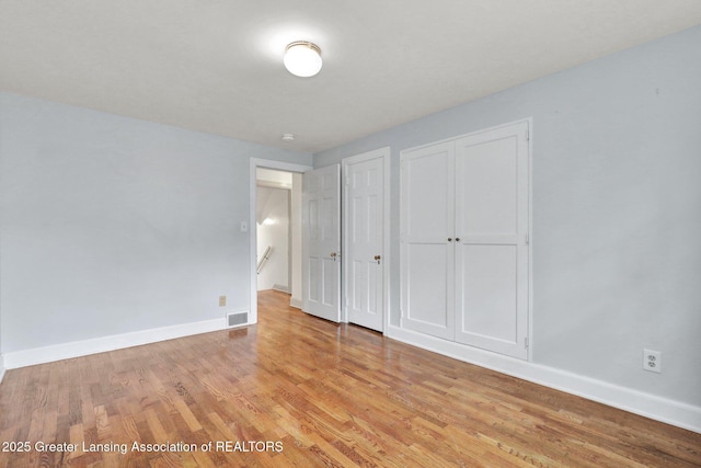 350 Kensington Rd, East Lansing, MI 48823 - unfurnished bedroom featuring light wood-style floors and baseboards