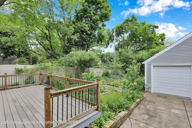 350 Kensington Rd, East Lansing, MI 48823 - wooden terrace featuring driveway, a fenced backyard, and a garage