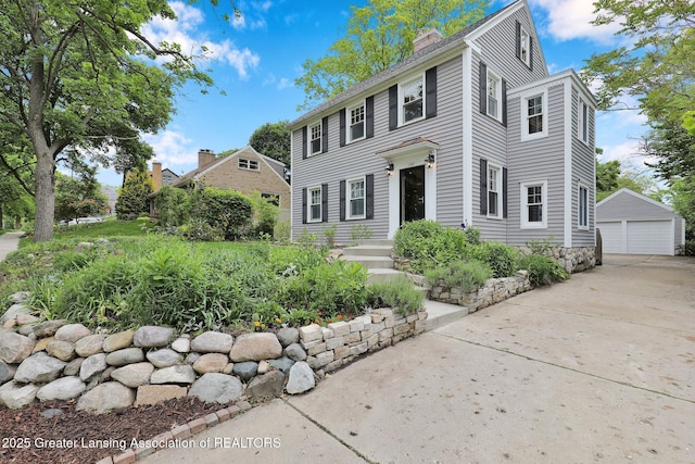 350 Kensington Rd, East Lansing, MI 48823 - colonial inspired home featuring a detached garage, a chimney, and an outbuilding