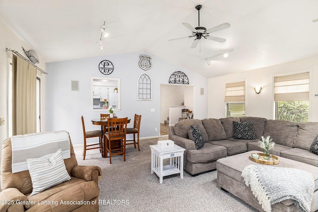 8450 Pineview Lake Dr, Linden, MI 48451 - living area with rail lighting, light carpet, vaulted ceiling, a ceiling fan, and baseboards