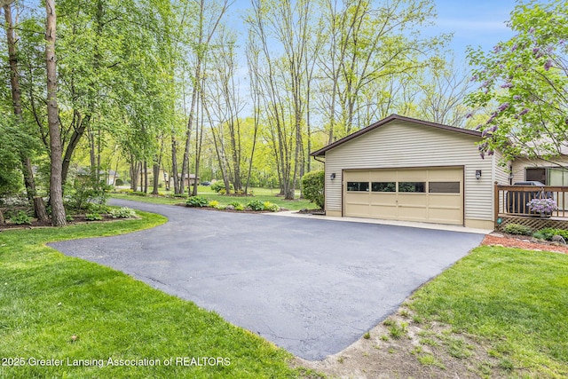 8450 Pineview Lake Dr, Linden, MI 48451 - view of side of home featuring driveway, a yard, an attached garage, and an outbuilding