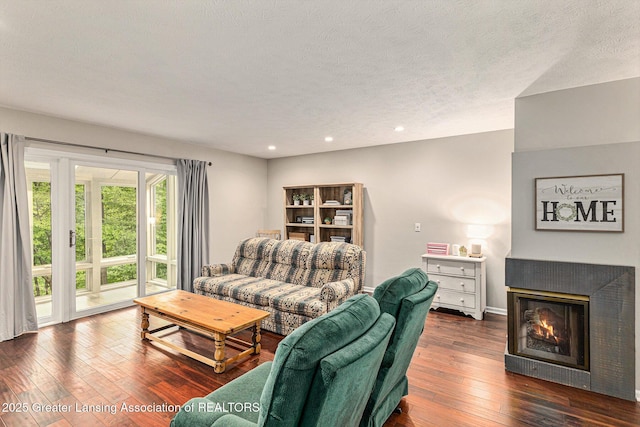 1146 S Ridge Rd, Lansing, MI 48917 - living room featuring hardwood / wood-style flooring, recessed lighting, a glass covered fireplace, baseboards, and a textured ceiling