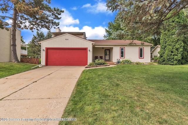 524 Dutch Hill Dr, Lansing, MI 48917 - view of front of home with an attached garage, driveway, and a chimney