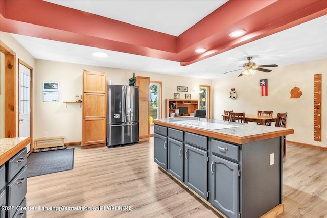 524 Dutch Hill Dr, Lansing, MI 48917 - kitchen featuring freestanding refrigerator, light wood-type flooring, light countertops, baseboards, and ceiling fan