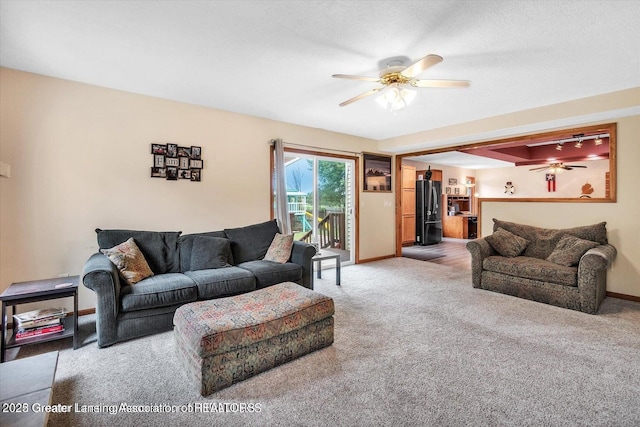 524 Dutch Hill Dr, Lansing, MI 48917 - carpeted living area featuring ceiling fan and baseboards