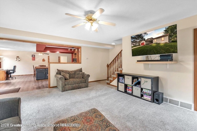 524 Dutch Hill Dr, Lansing, MI 48917 - carpeted living room featuring stairway, ceiling fan, and baseboards