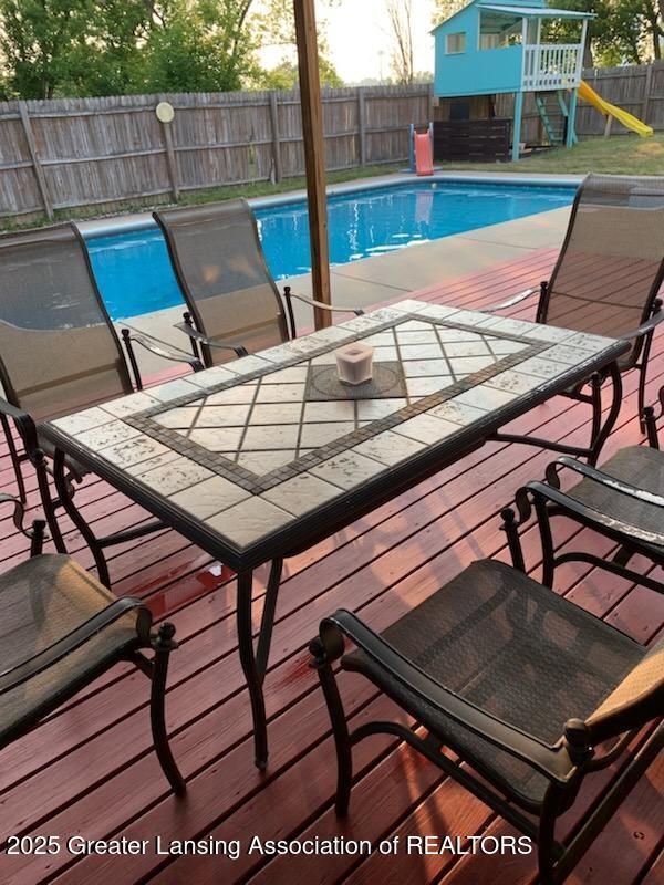 524 Dutch Hill Dr, Lansing, MI 48917 - view of pool featuring a fenced backyard, a playground, and outdoor dining space