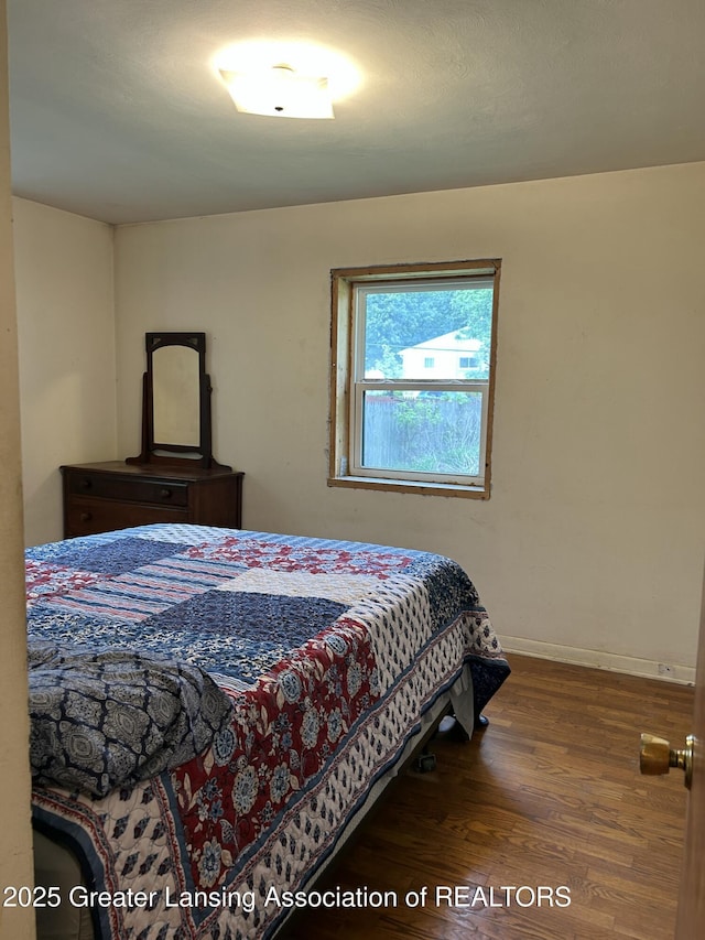657 Spartan Ave, East Lansing, MI 48823 - bedroom featuring wood finished floors and baseboards