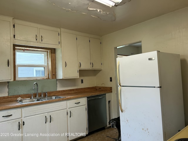 657 Spartan Ave, East Lansing, MI 48823 - kitchen featuring freestanding refrigerator, dishwashing machine, a sink, and white cabinets