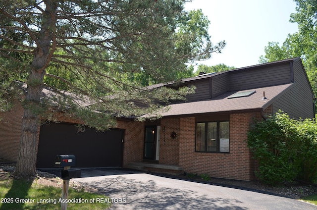 2397 Emerald Forest Cir Unit 26, East Lansing, MI 48823 - mid-century inspired home featuring an attached garage, asphalt driveway, brick siding, and a shingled roof
