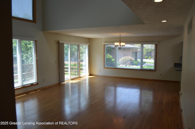 2397 Emerald Forest Cir Unit 26, East Lansing, MI 48823 - empty room featuring a chandelier, wood finished floors, and recessed lighting