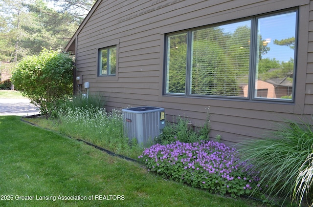2397 Emerald Forest Cir Unit 26, East Lansing, MI 48823 - view of home's exterior with a cooling unit and a yard