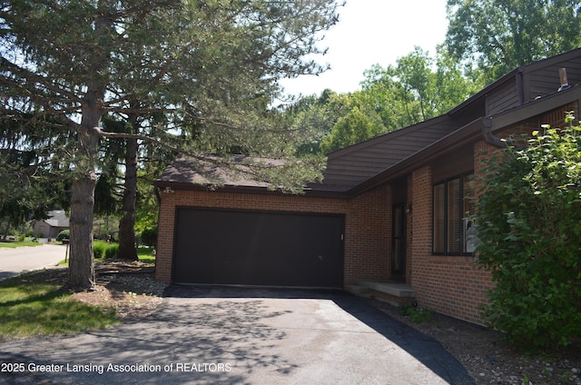 2397 Emerald Forest Cir Unit 26, East Lansing, MI 48823 - garage featuring asphalt driveway