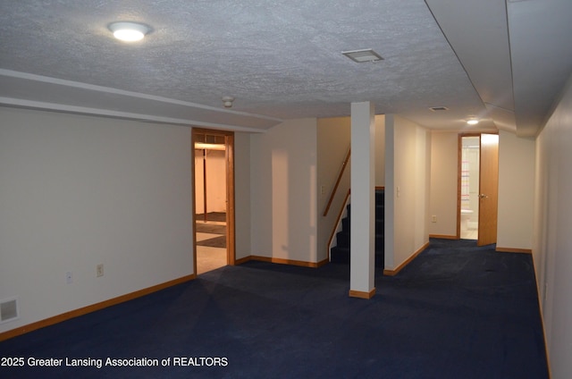 2397 Emerald Forest Cir Unit 26, East Lansing, MI 48823 - finished below grade area featuring stairway, a textured ceiling, and carpet floors